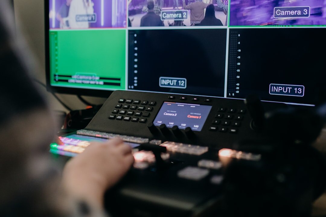 Broadcast control room with multiple video monitors showing camera feeds